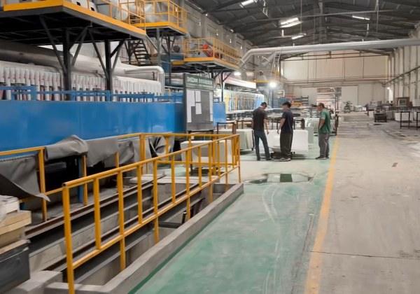 Workers along the heat-bending production line
